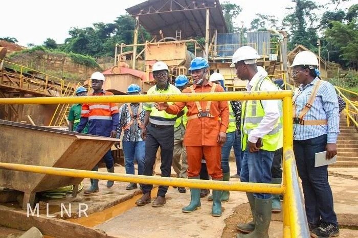 Imgi 166 Mining communities 1 Mr Duker middle inspecting some of the mining equipment used by Kibi Goldfields during the visit